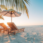 Lounge chairs and umbrella on the beach at sunrise